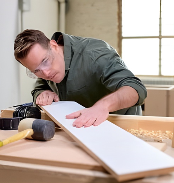Founder looking at wood